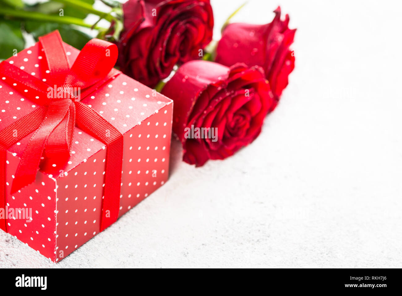 Red roses flower and present box on white Stock Photo - Alamy