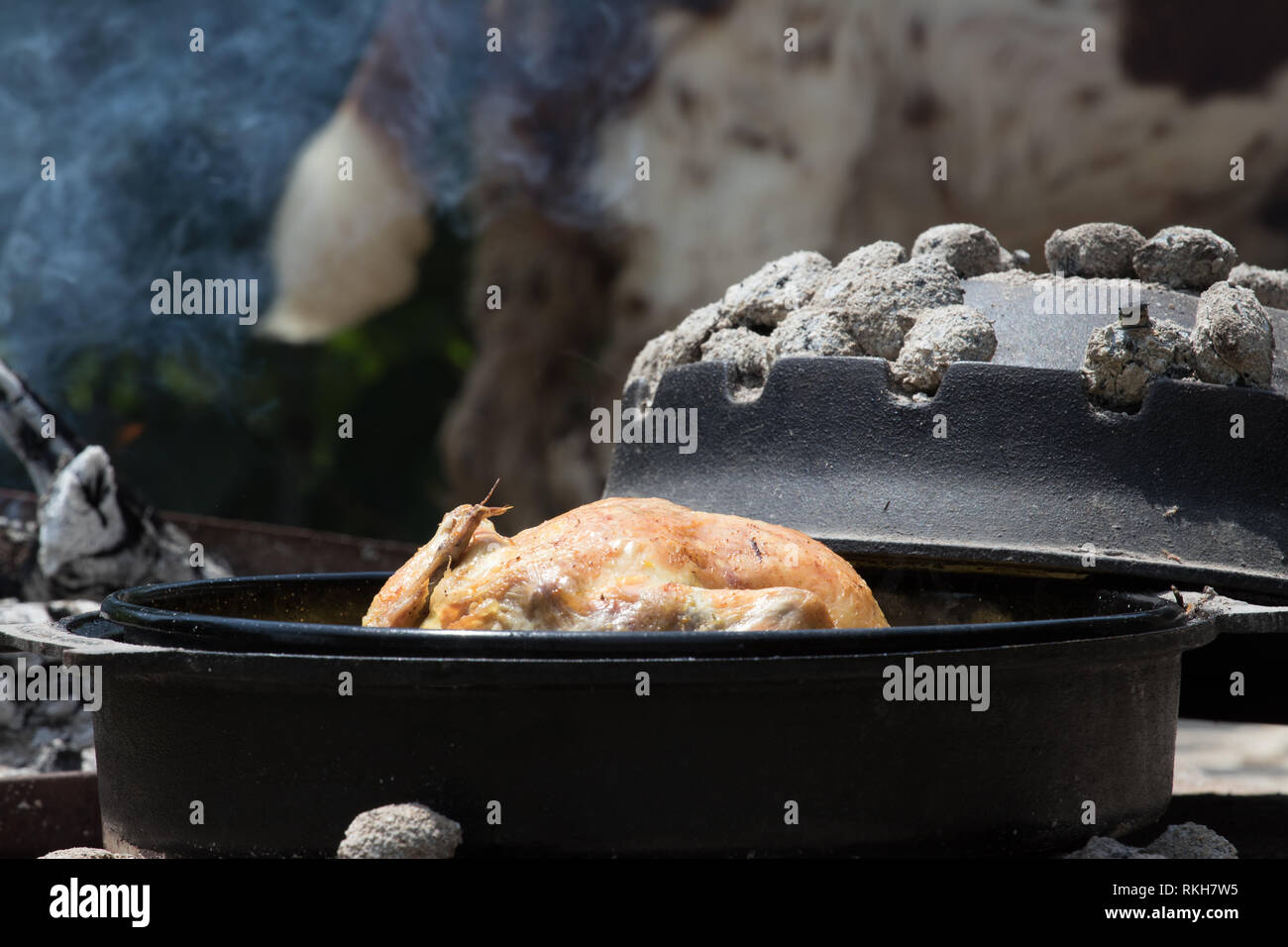 Cooking of traditional Croatian meal Peka in metal pots called sac sach
