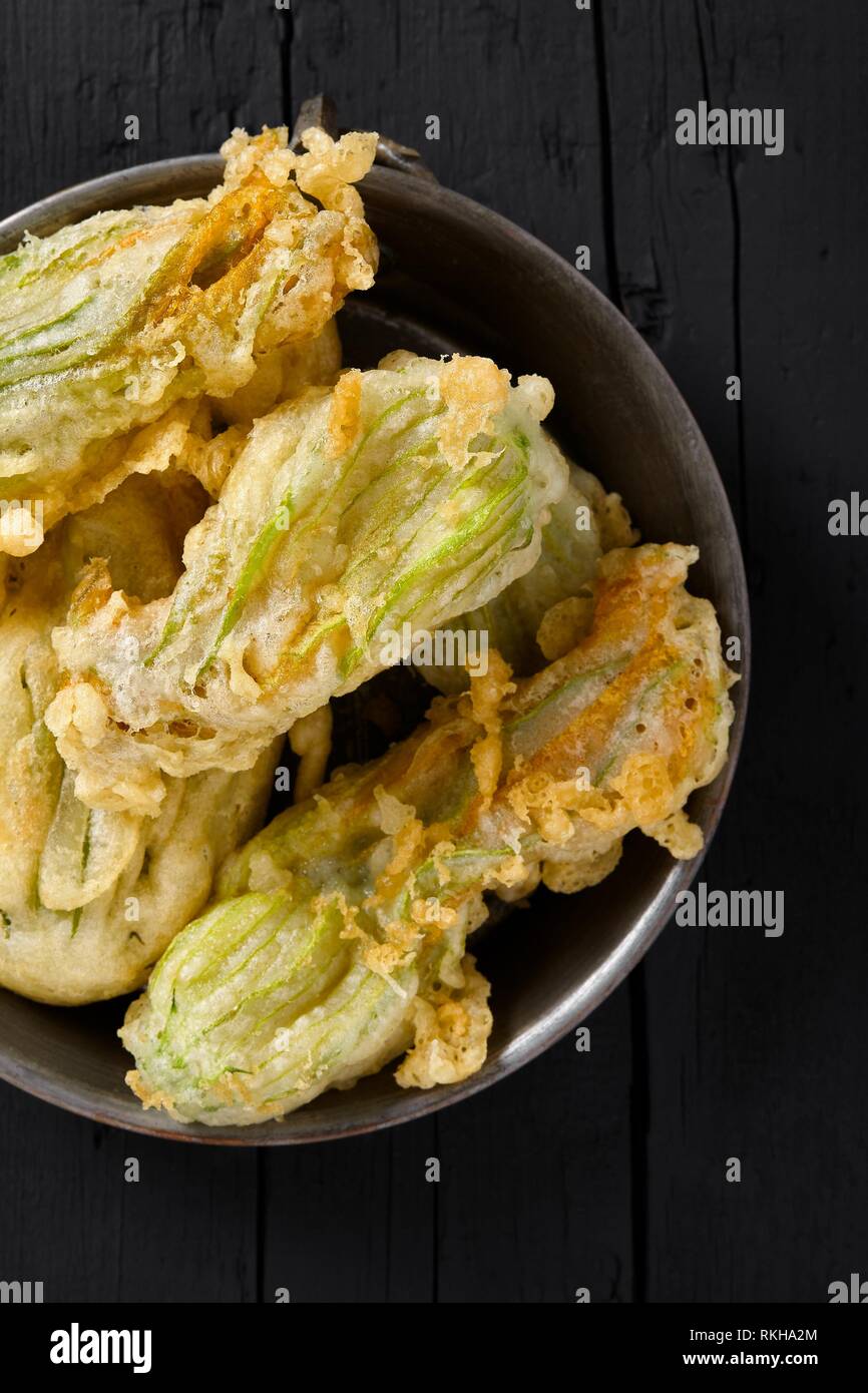 Plate with fried zucchini flowers, typical plate of the Italian cuisine. Top view shot Stock