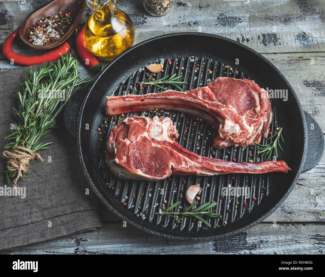 Raw meat lamb veal ribs loin on the grill pan, spices , chops ready for cooking Stock Photo