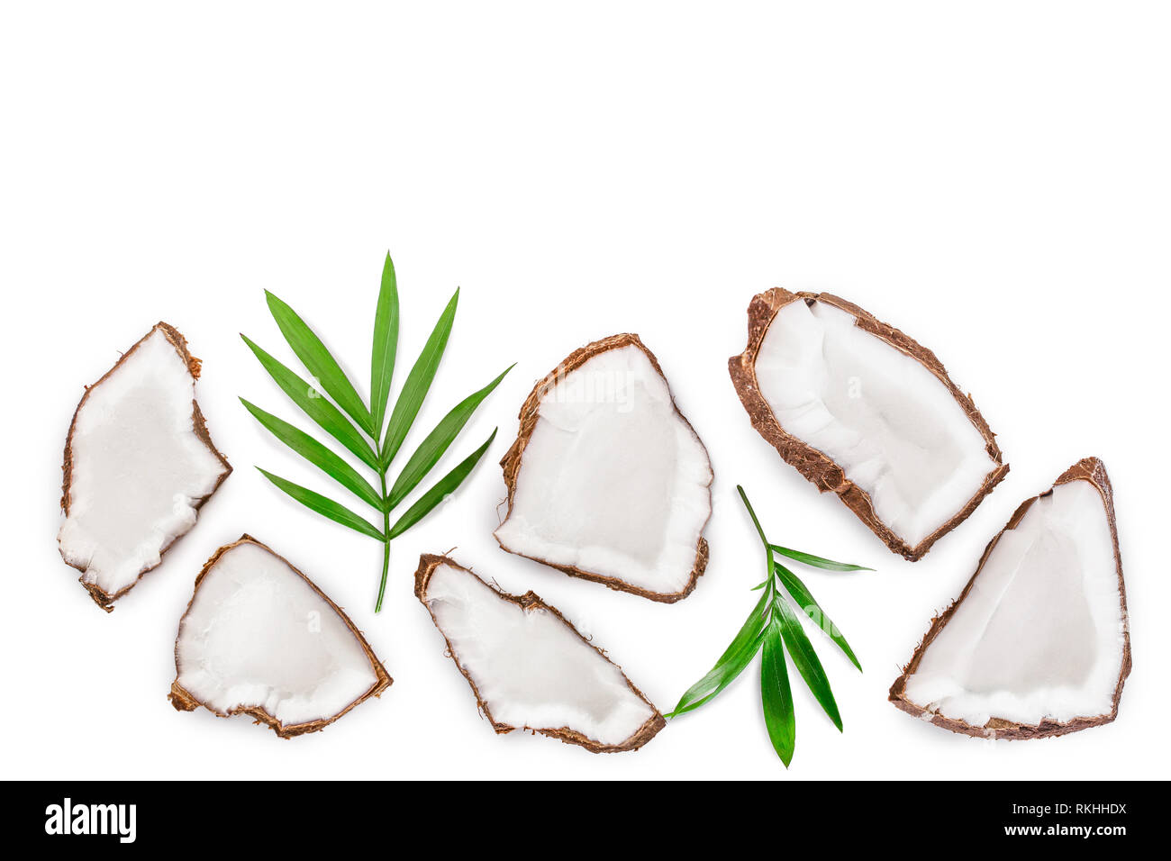 piece of coconut with leaves isolated on white background with copy space for your text. Top view. Flat lay Stock Photo