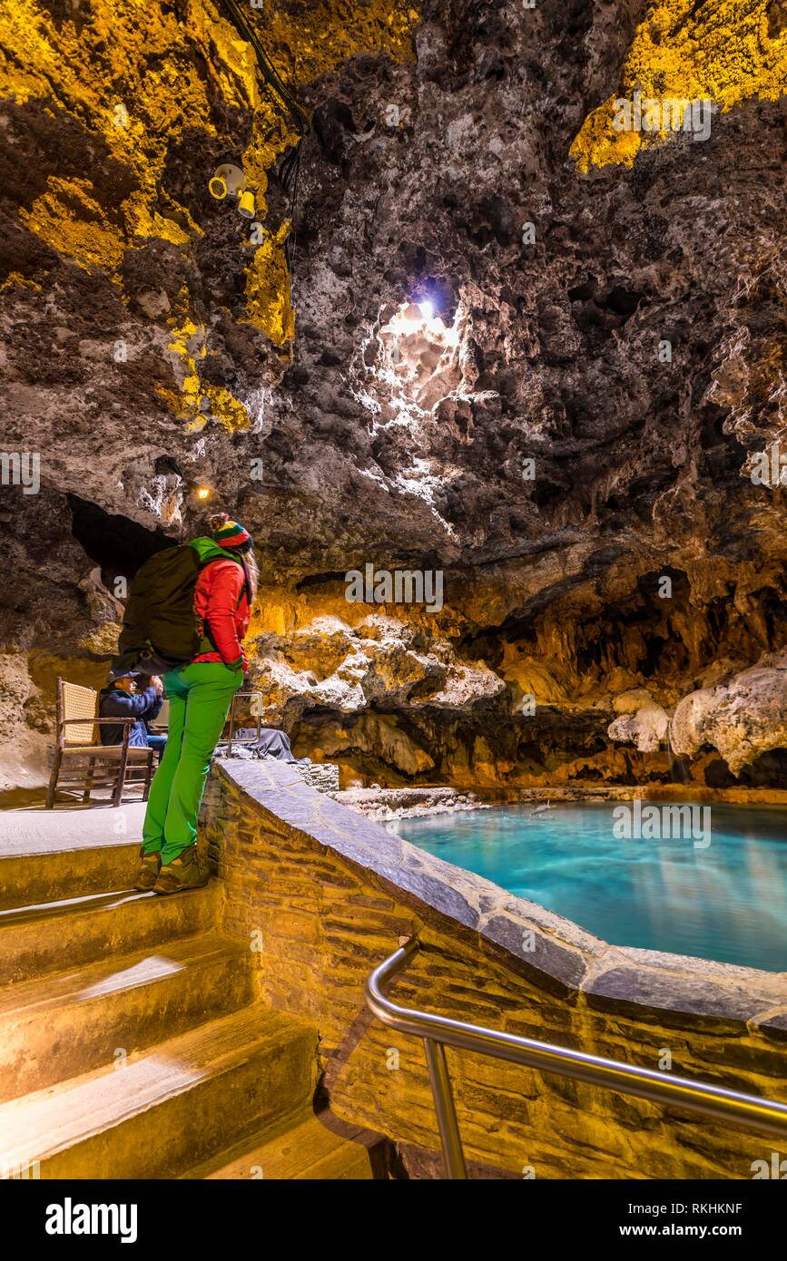 Young woman in a cave with a geothermal spring, Cave and Basin National Historic Site, Banff National Park, Alberta, Canada Stock Photo
