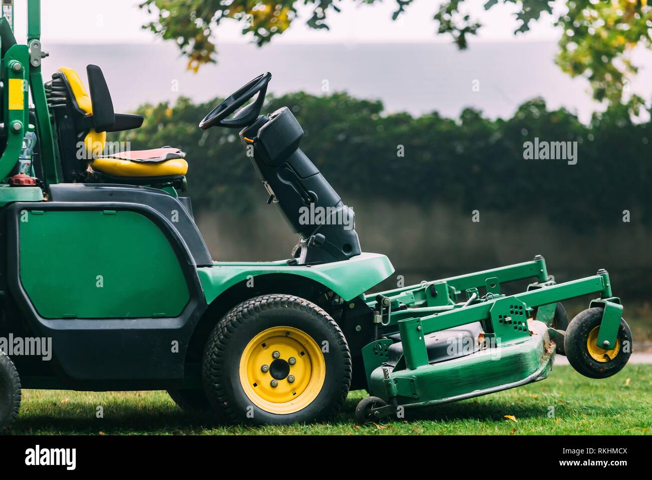 Lawn Mower Tractor On Green Grass. Garden Special Technique Stock