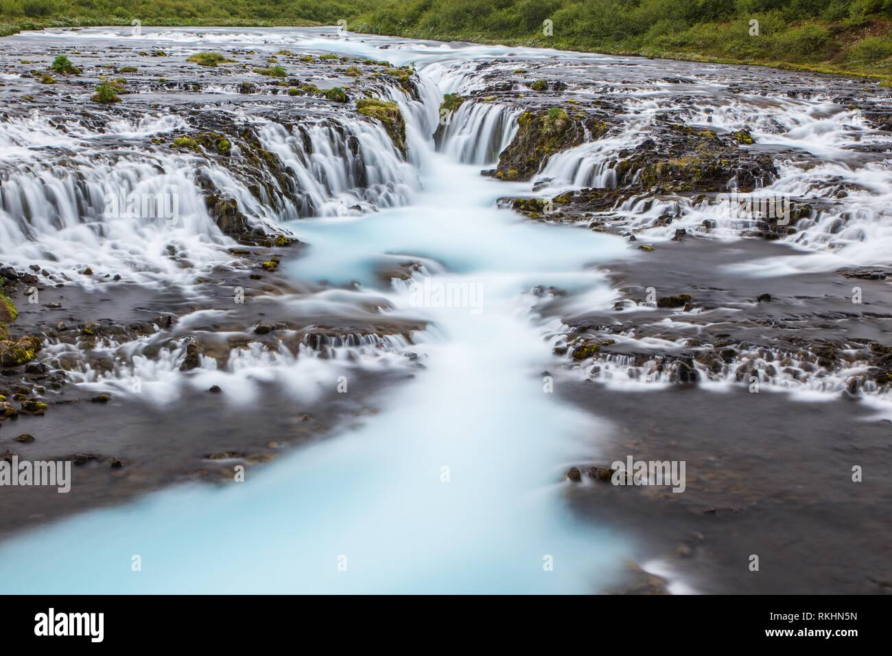 Detail of bright powerful Bruarfoss waterfall in Iceland with cyan water. Stock Photo