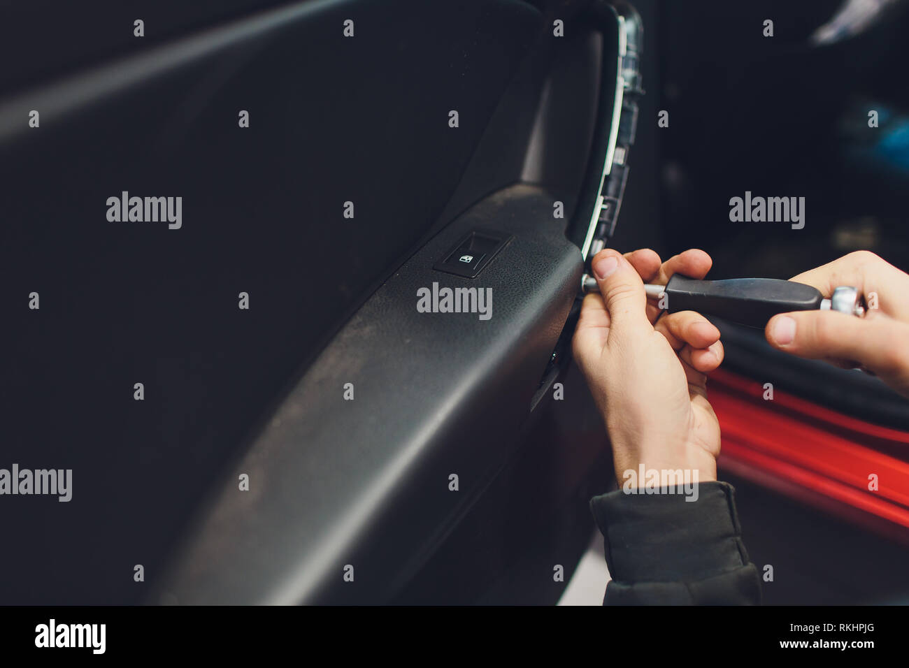 Mechanic installing car central door lock motor Stock Photo