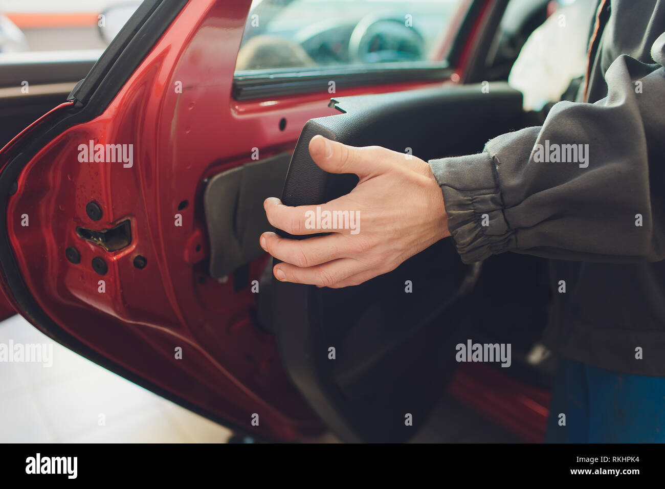 Mechanic installing car central door lock motor Stock Photo