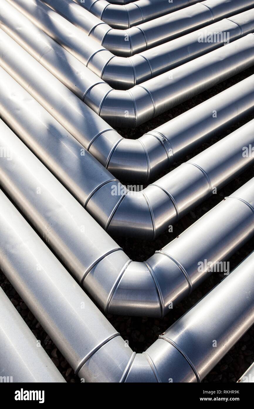 Pipes for heating and air conditioning recuperator at building roof. Corner elbow joints. Stock Photo