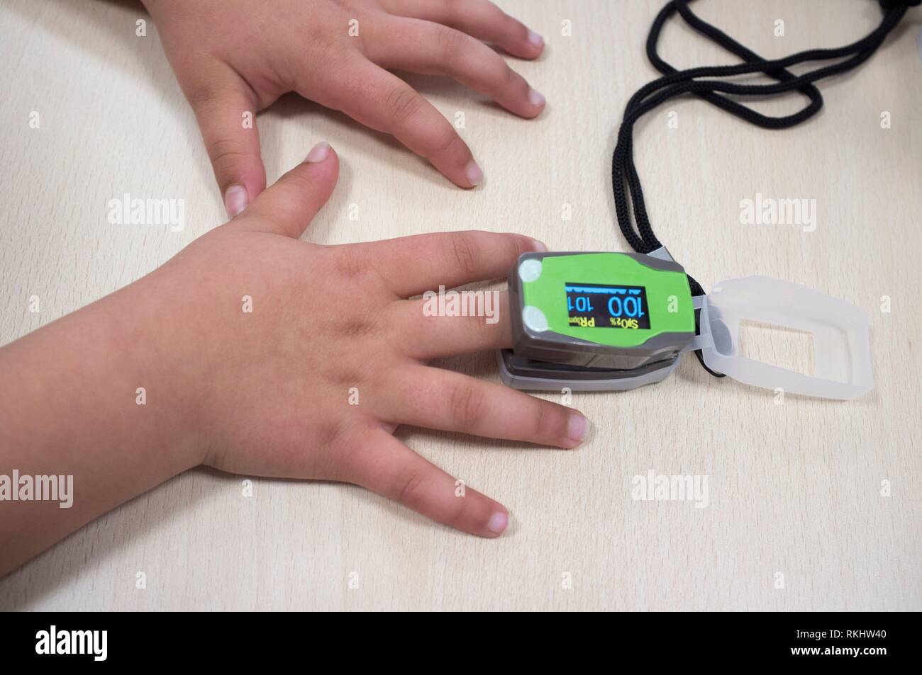 Doctor measuring little girl's measuring oxygen and heart rate. Periodical pediatric review concept. Stock Photo