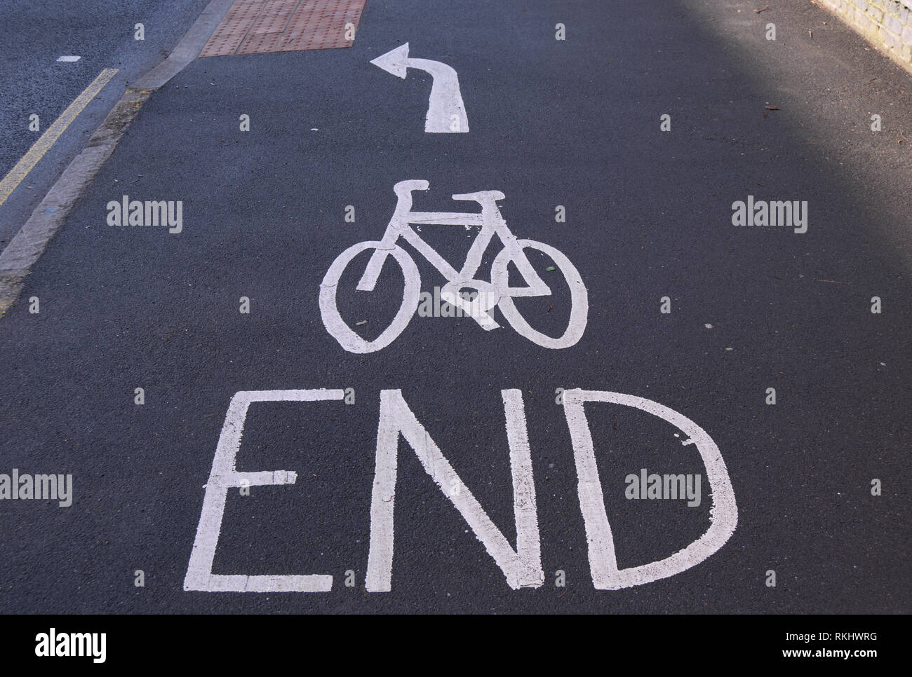 cycle lane markings on portsmouth road, kingston, surrey, england, denoting the end of a cycle lane and that cyclists should turn left Stock Photo
