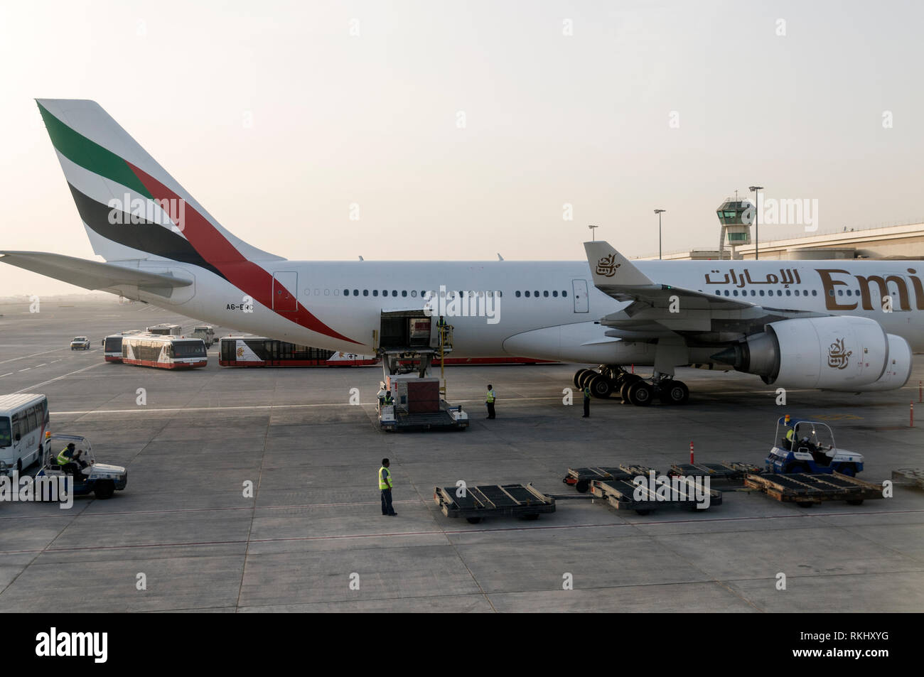 Ground crew loading cargo on board one of the Emirates passenger aircraft Dubai International
