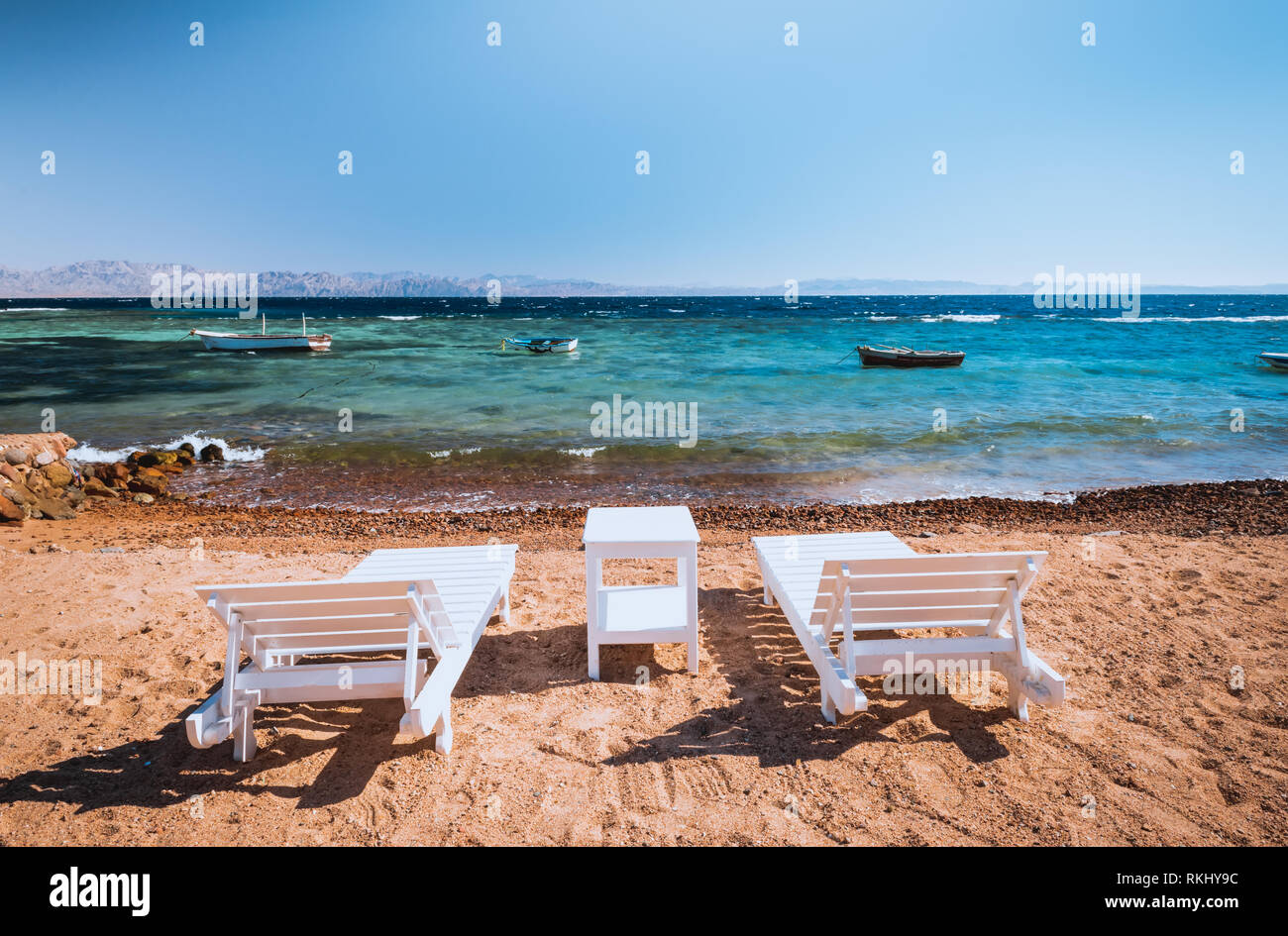 lounge chairs on beautiful tropical beach at Egypt, Dahab Stock Photo