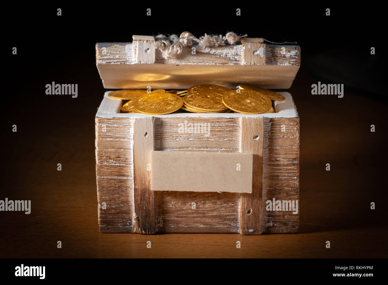 Shiny gold coins (Austrian ducats) in a small wooden treasure box Stock Photo