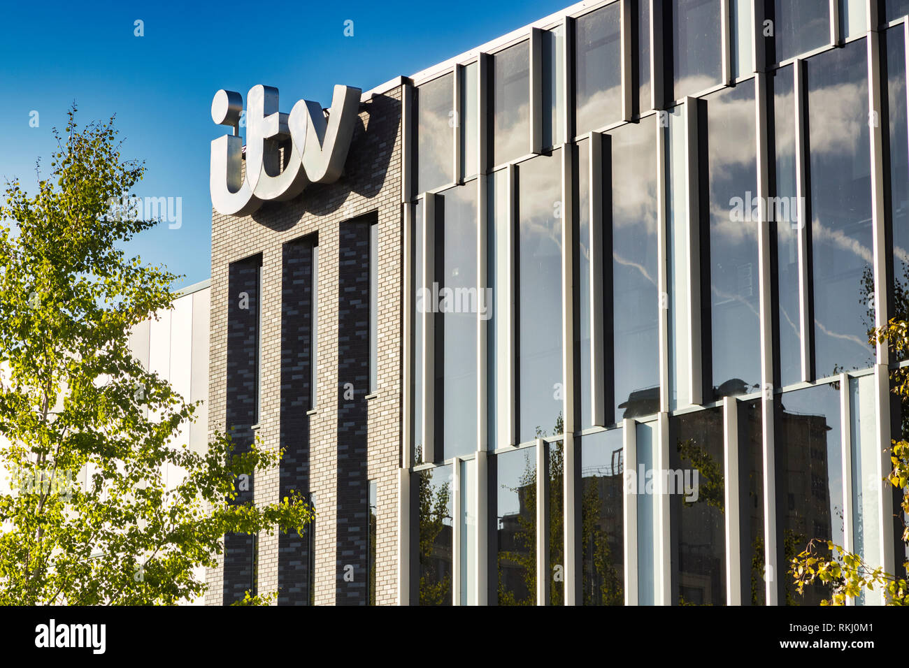 2 November 2018: Salford Quays, Manchester, UK - ITV building with logo, beautiful autumn day with clear blue sky, bright foliage. Stock Photo