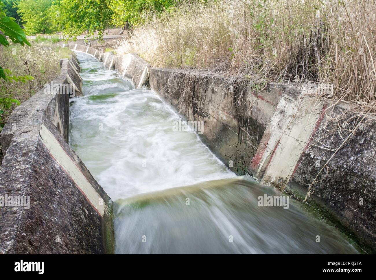 Concrete-lined waterfalls portion at irrigation canal, Low Guadiana Lands, Vegas Bajas, Extremadura, Spain. Stock Photo