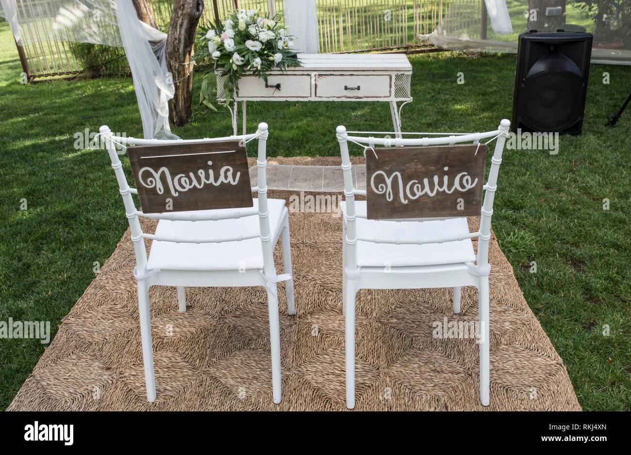 Chairs for bride and groom at altar. Spanish sign Novia y Novio. Stock Photo