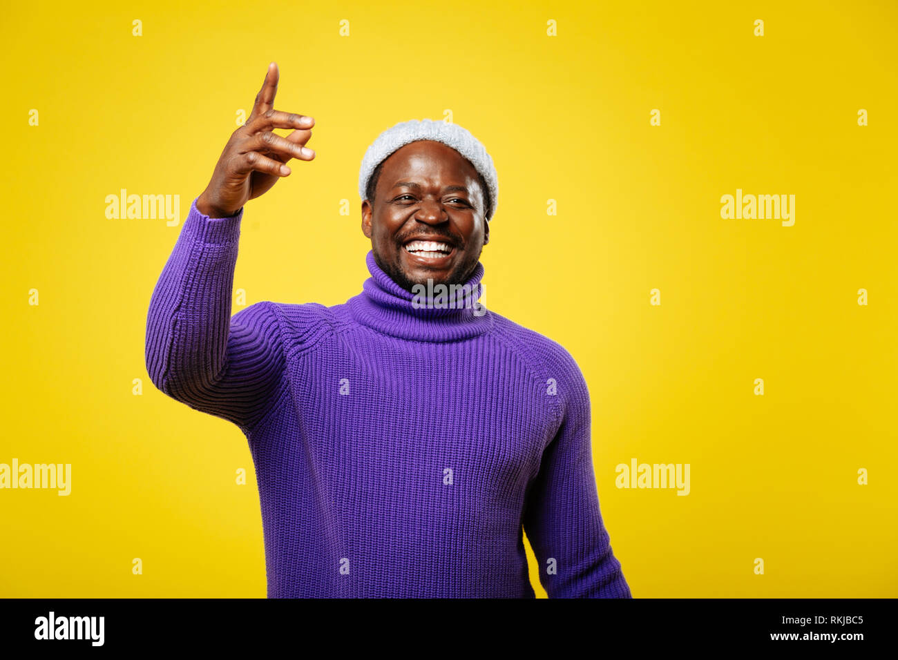Positive delighted African man demonstrating his smile Stock Photo - Alamy