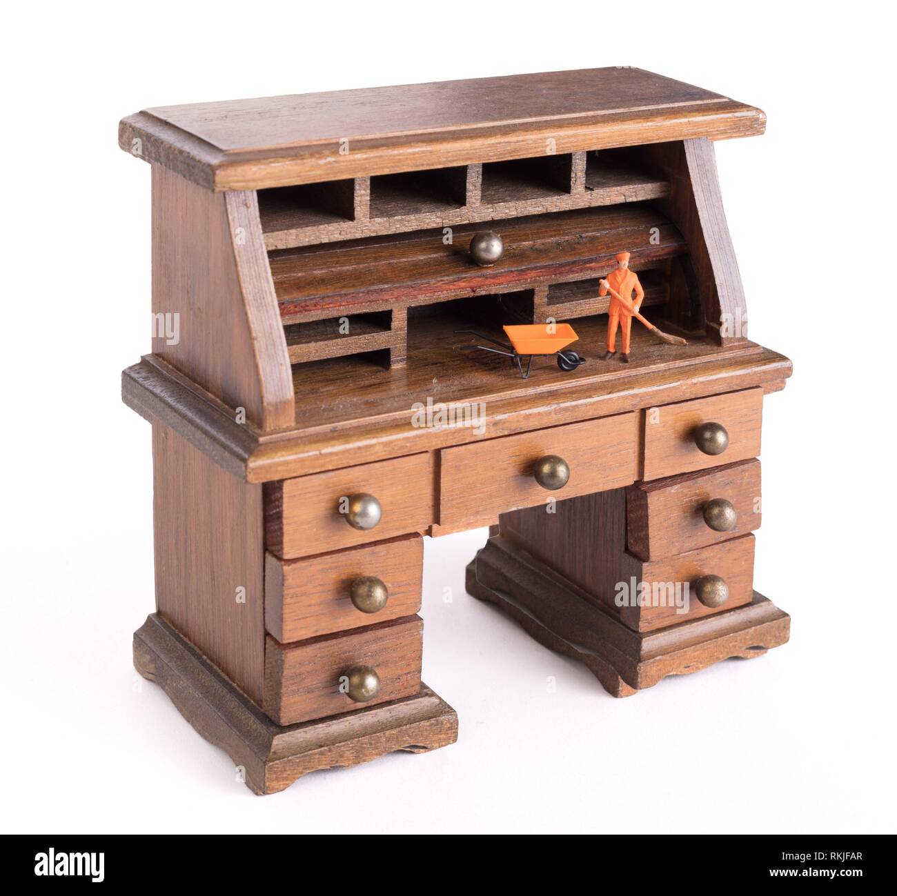 Small vintage wooden desk, small man cleaning Clean desk policy Stock