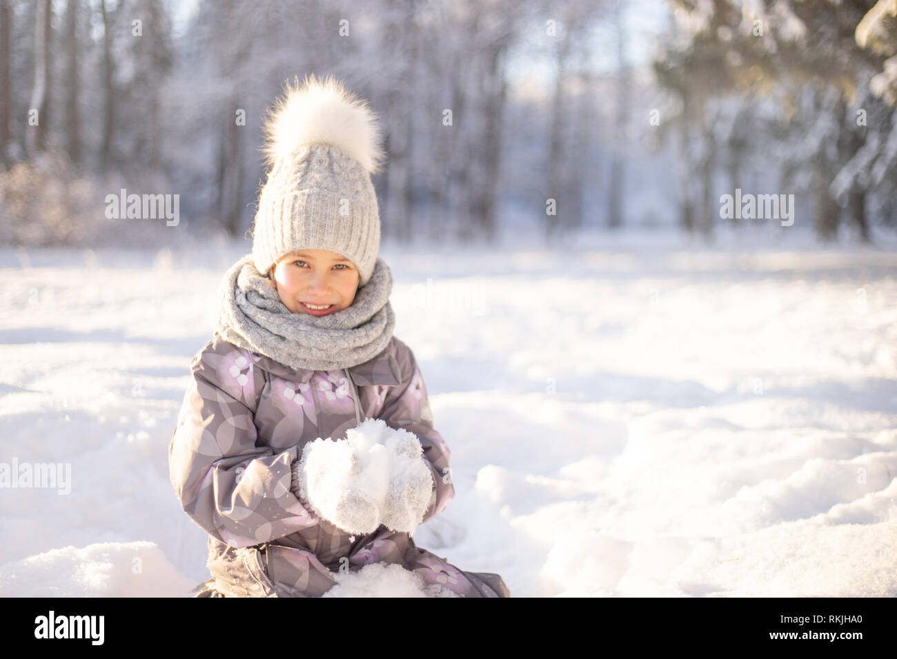 Child playing with snow in winter. Children catch snow flakes Stock ...
