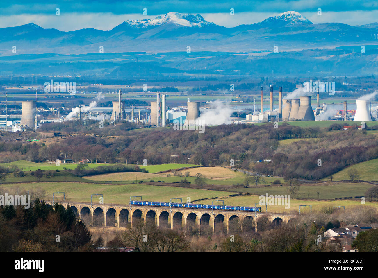 Railway viaduct and INEOS Grangemouth petrochemical plant and oil refinery in Scotland, UK Stock Photo