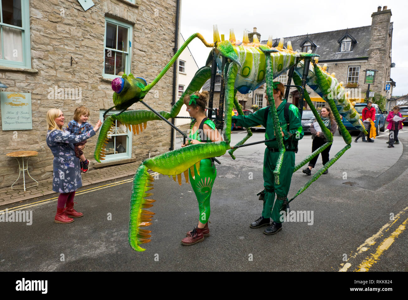 Large green praying mantis an automaton part of an art project being paraded around the town centre of Hay on Wye Powys Wales UK Stock Photo