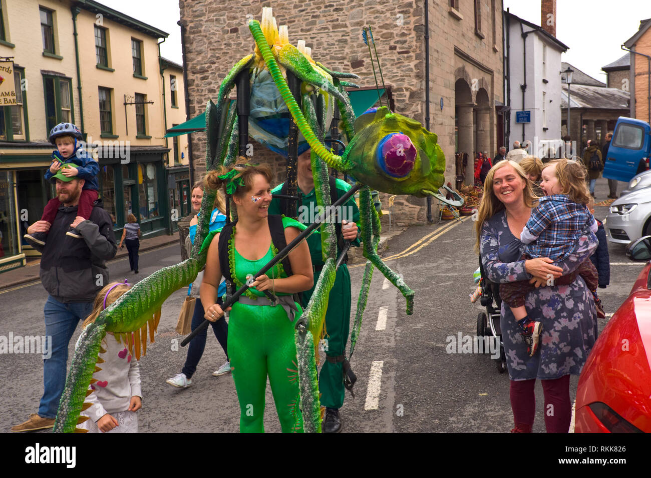 Large green praying mantis an automaton part of an art project being paraded around the town centre of Hay on Wye Powys Wales UK Stock Photo