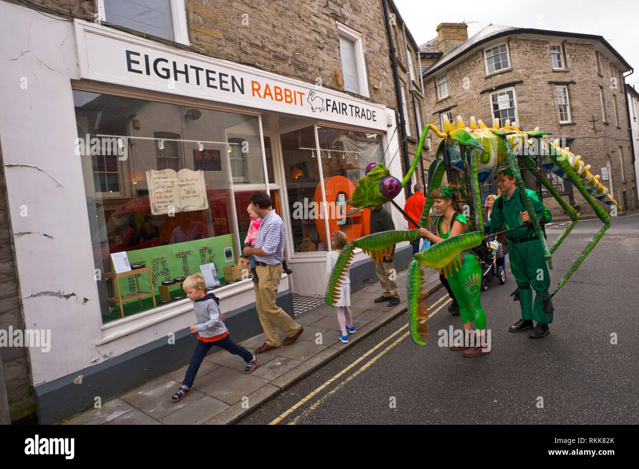 Large green praying mantis an automaton part of an art ptoject being paraded around the town centre of Hay on Wye Powys Wales UK Stock Photo