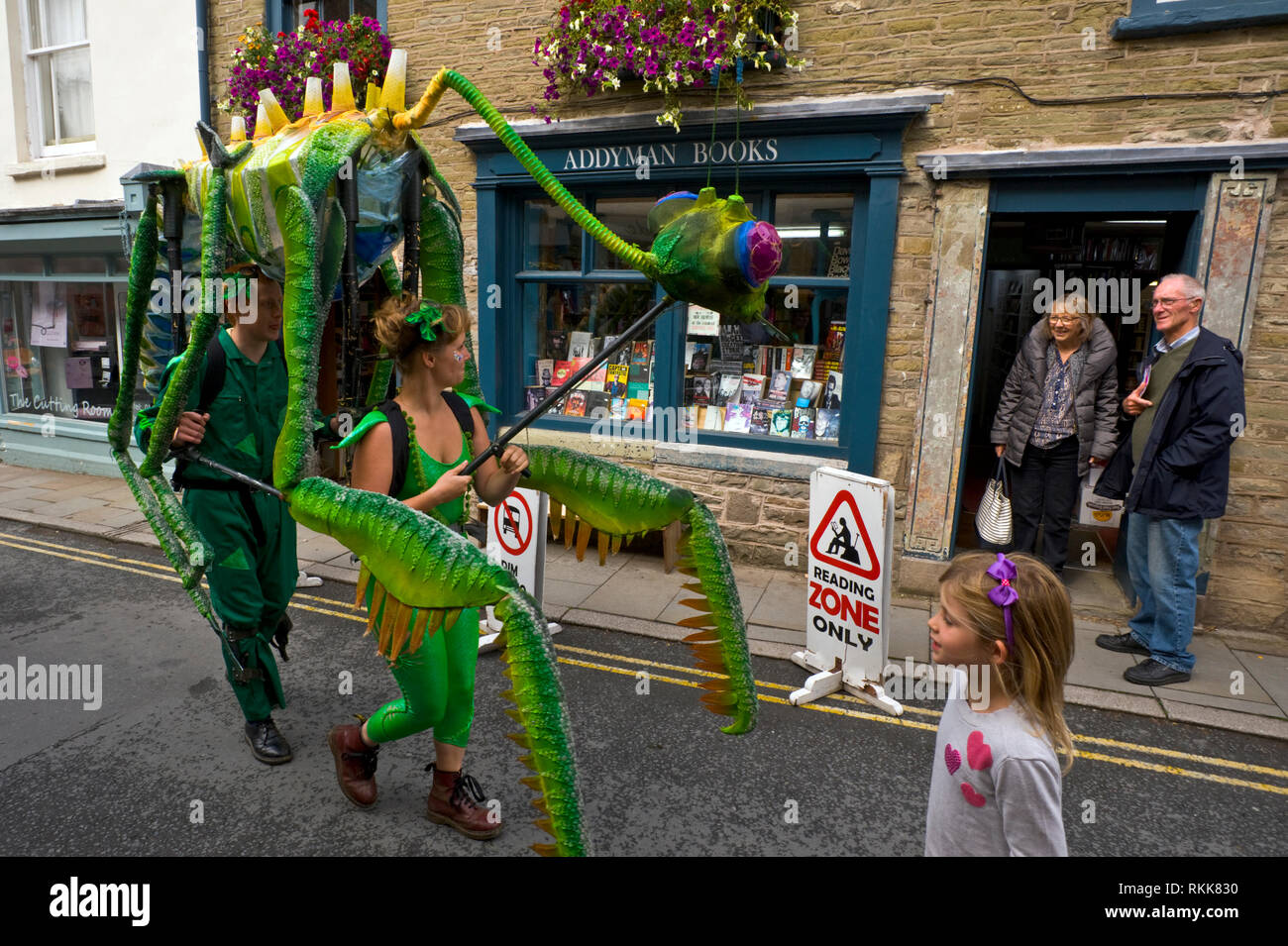 Large green praying mantis an automaton part of an art project being paraded around the town centre of Hay on Wye Powys Wales UK Stock Photo