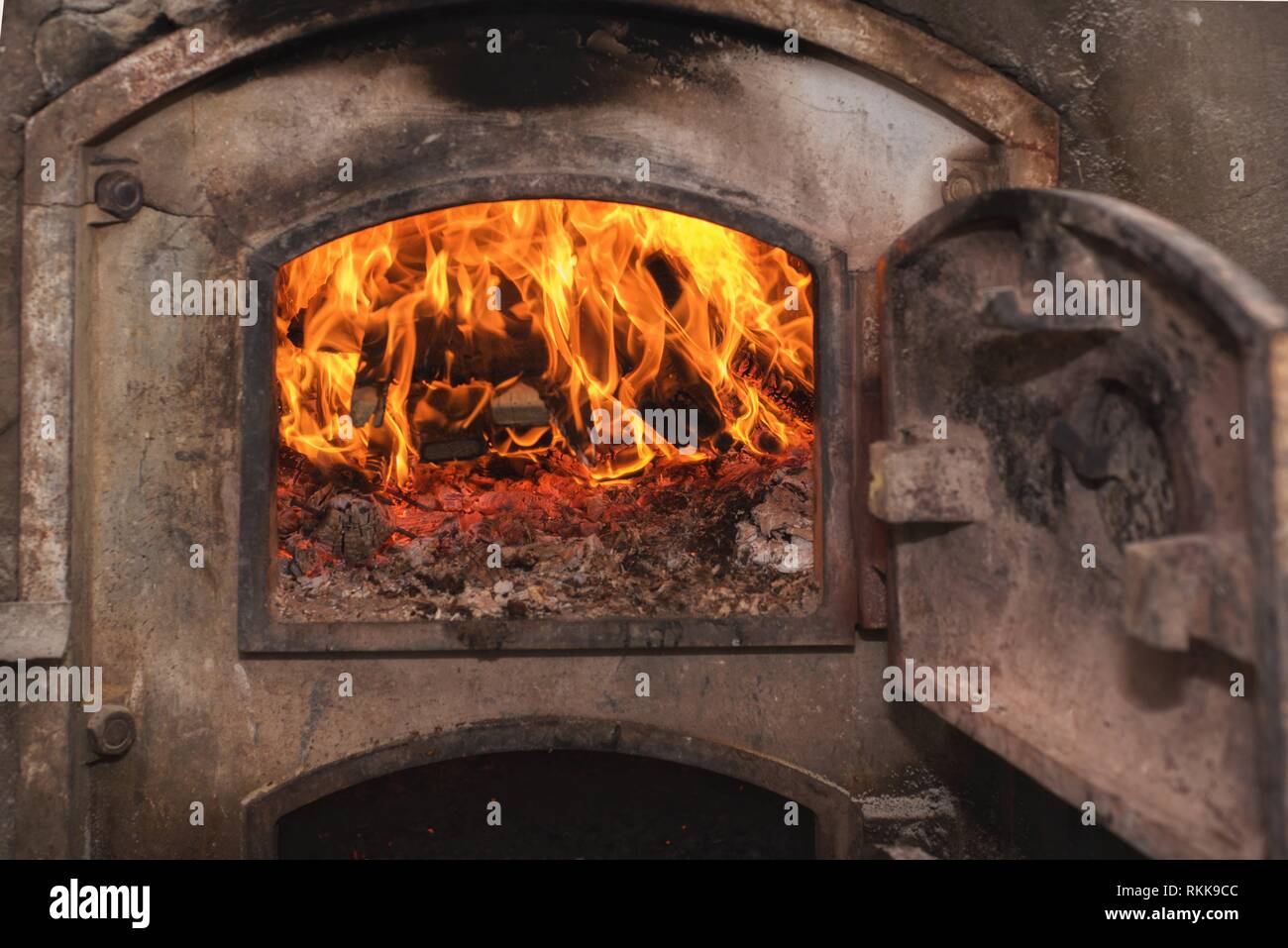 Fire wood in ancient rust stove Stock Photo Alamy