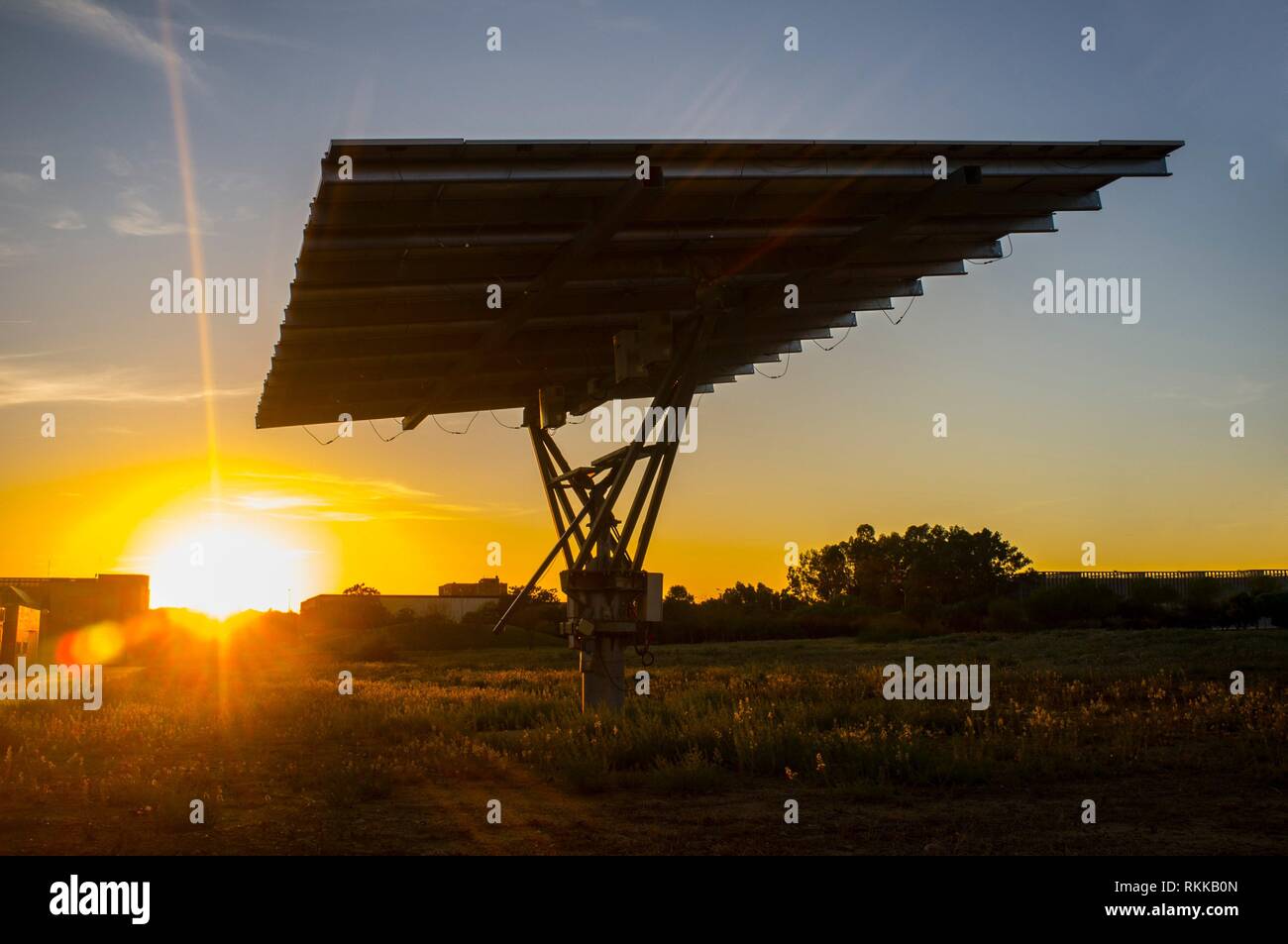 Urban photovoltaic panel with solar tracker placed outdoors building. Stock Photo