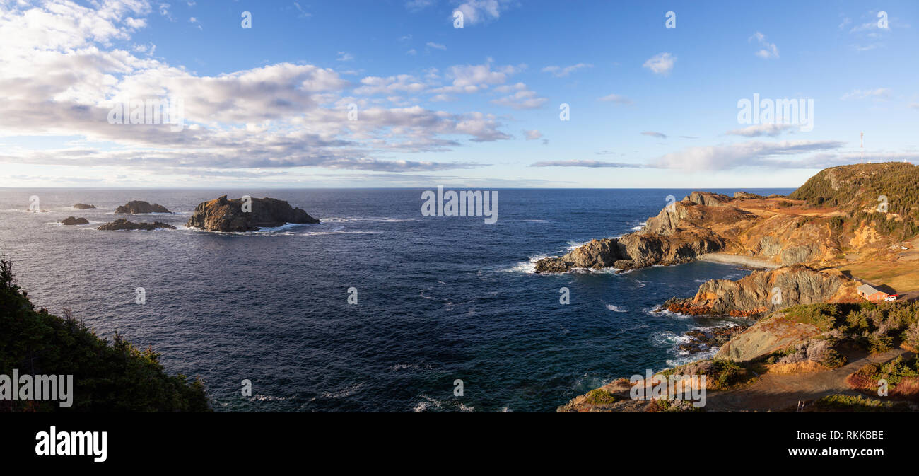 Striking panoramic seascape view on a rocky Atlantic Ocean Coast during a vibrant sunset. Taken at Crow Head, North Twillingate Island, Newfoundland a Stock Photo