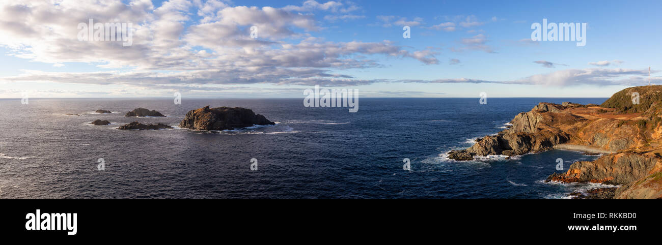 Striking panoramic seascape view on a rocky Atlantic Ocean Coast during a vibrant sunset. Taken at Crow Head, North Twillingate Island, Newfoundland a Stock Photo