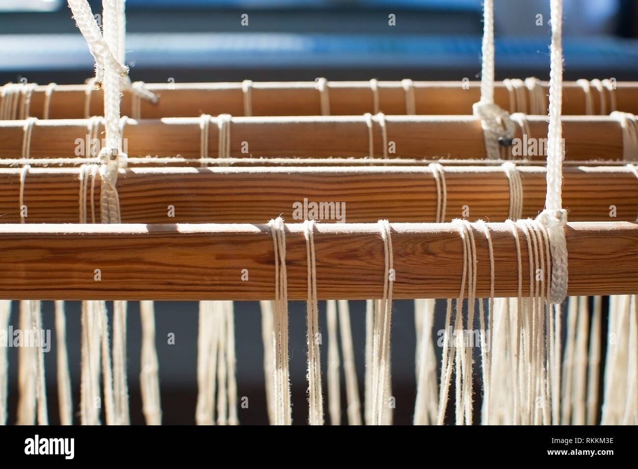 Closeup of loom threads and wood pins in sunlight. Stock Photo