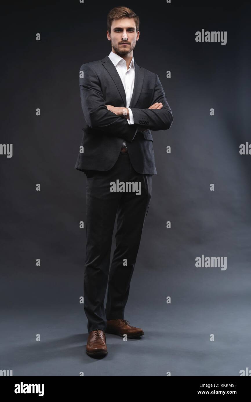 Full length portrait of a handsome young businessman dressed in suit ...
