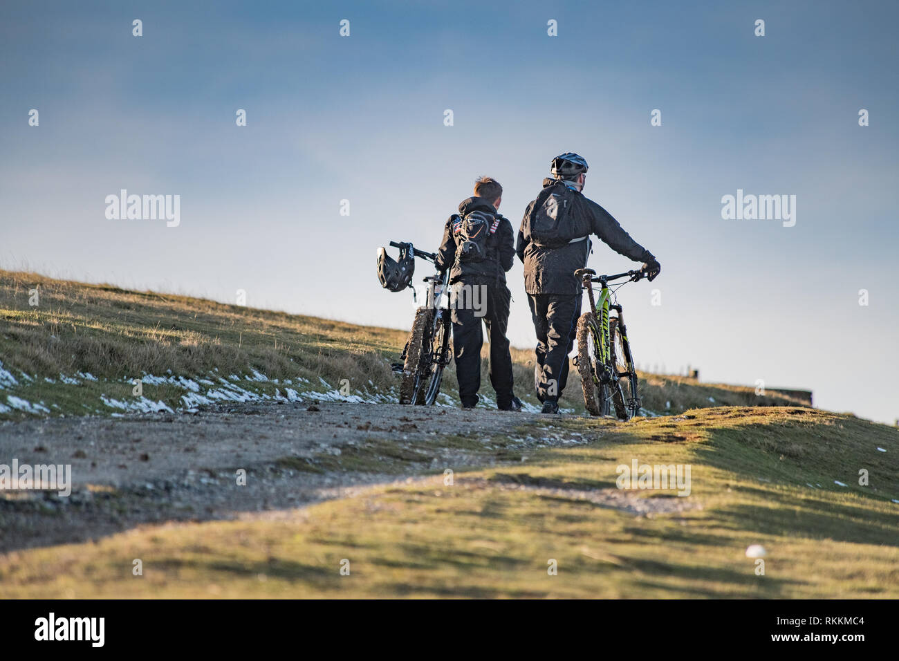 Cyclists pushing bikes up hill hires stock photography and images Alamy