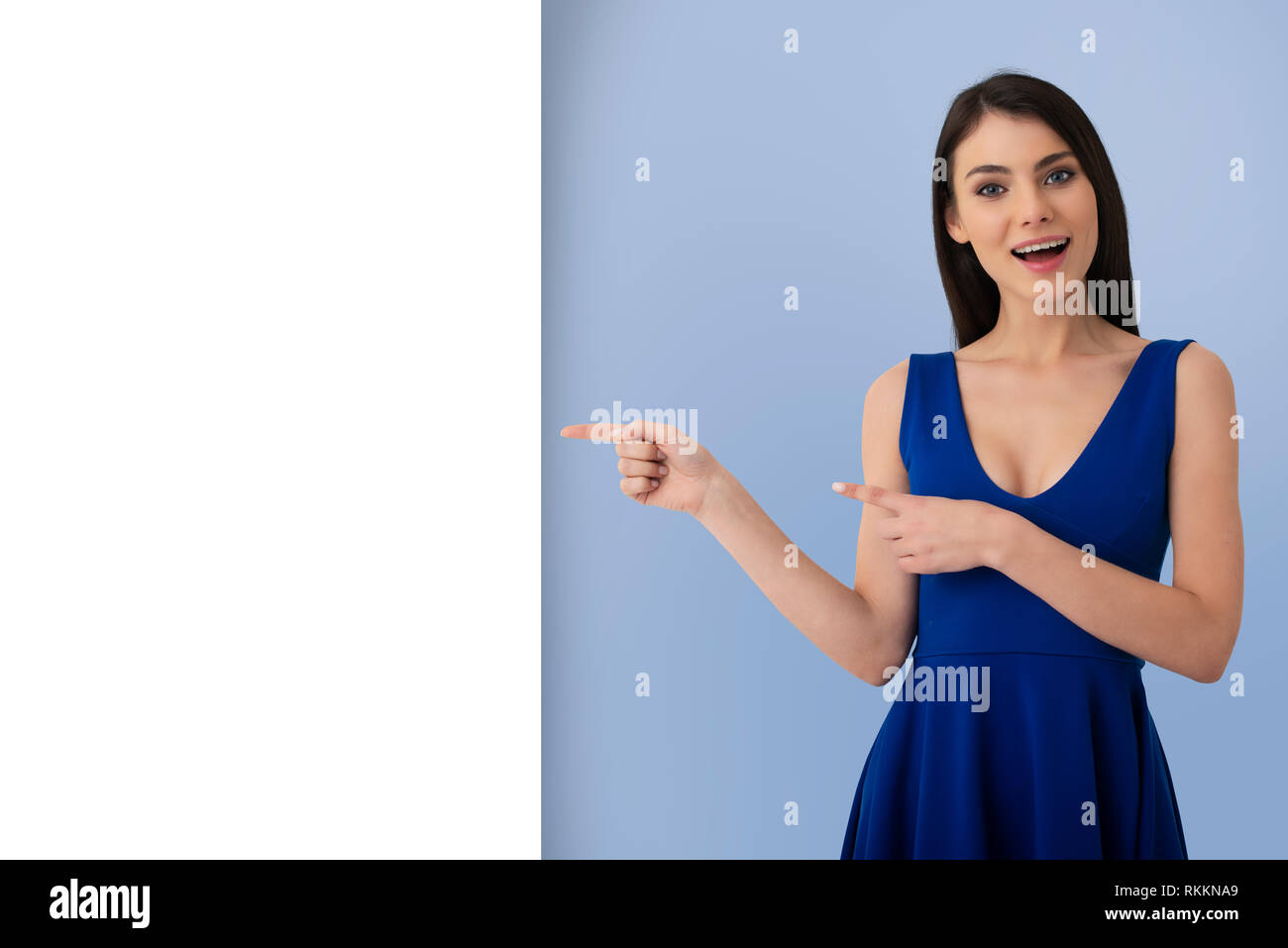 Surprised girl indicates a blank space for your text Stock Photo