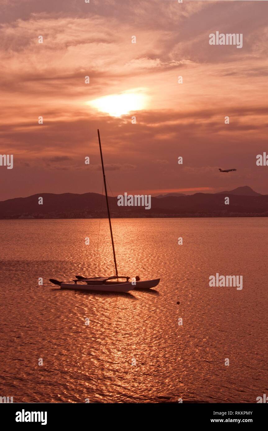 Beautiful sunset view over Palma bay with moored sailboat on a sunny summer evening in July, Mallorca, Spain. Stock Photo