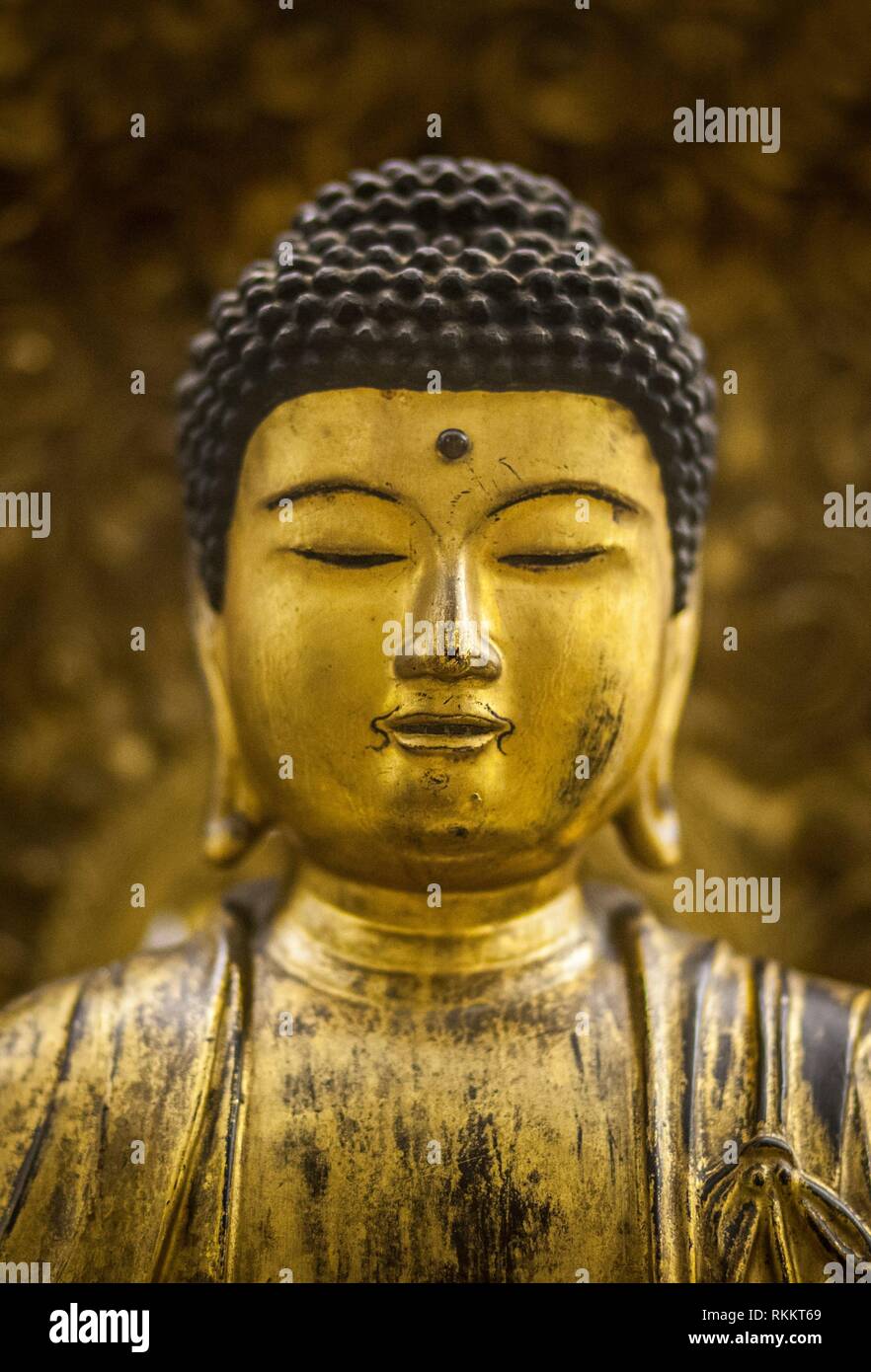 Thailand golden buddha figurine Well-dressed. Closeup. Stock Photo