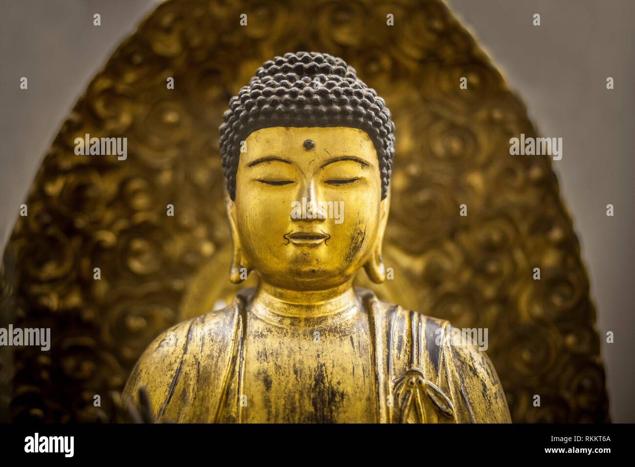 Thailand golden buddha figurine Well-dressed. Closeup. Stock Photo