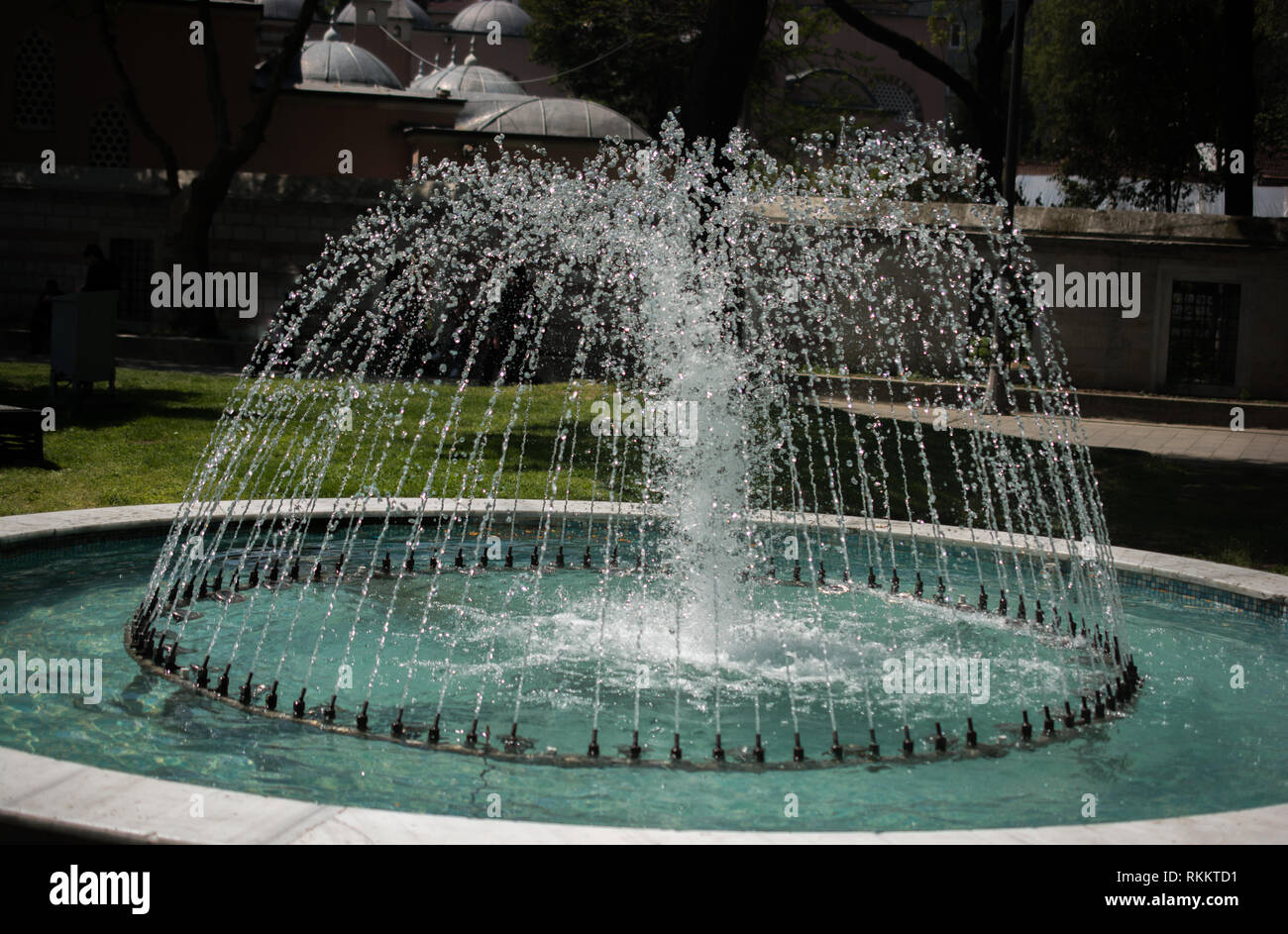 The fountains gushing sparkling water in a pool in a park Stock Photo