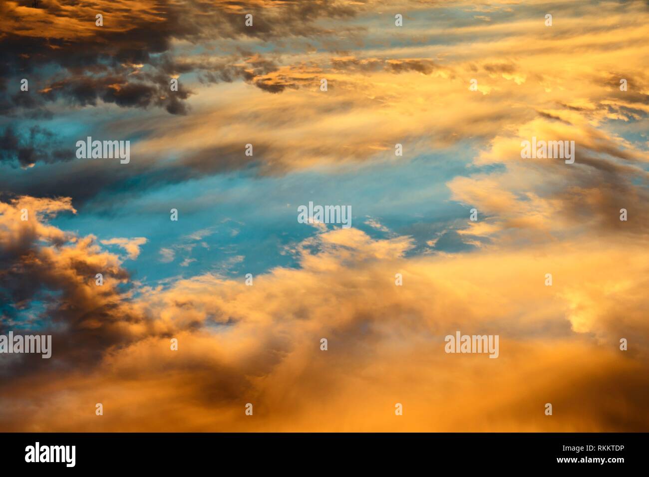 Colorful Heavenly Orange Warm Clouds On Sky at Sunset. Stock Photo
