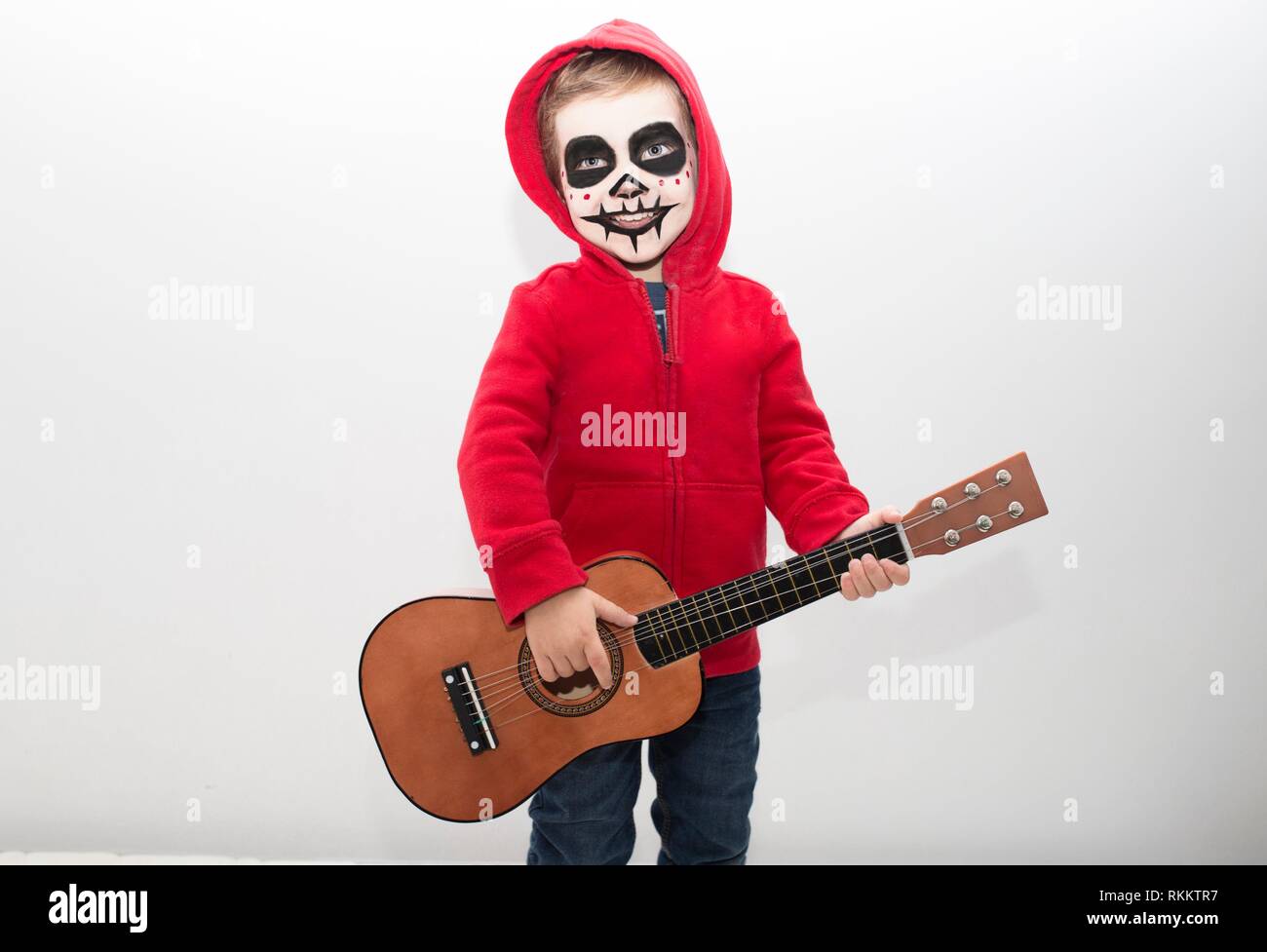 Little boy costumed as protagonist of Coco movie. Isolated over white. Stock Photo