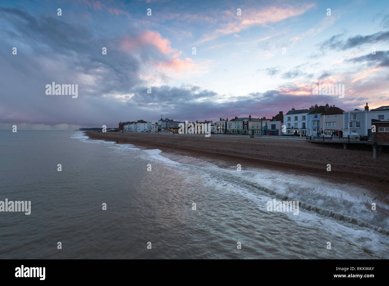 Pink clouds and the view from Deal Pier looking across towards Dover during a February afternoon just before sunset. Stock Photo