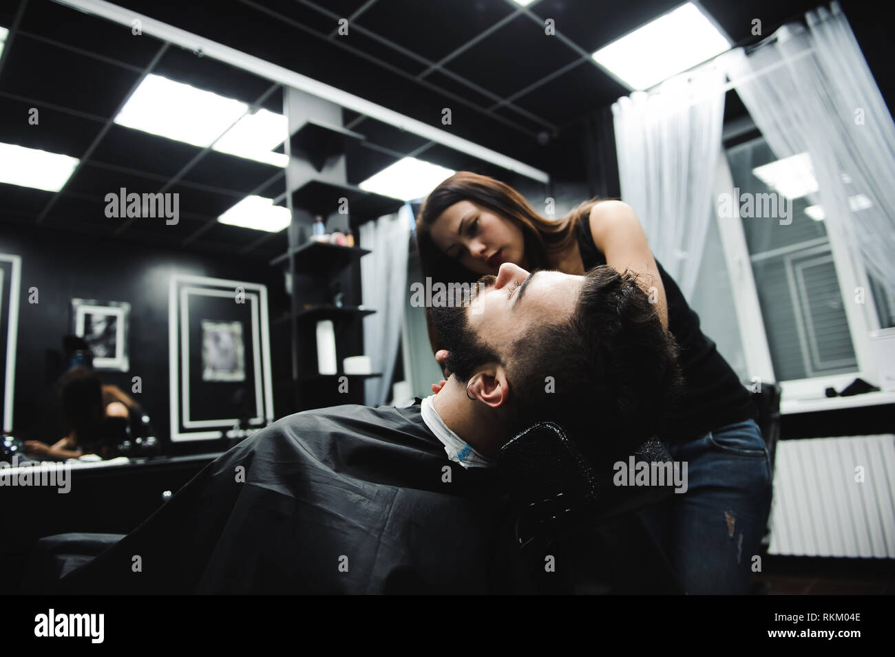 Master Cuts Hair And Beard Of Men In The Barbershop Hairdresser