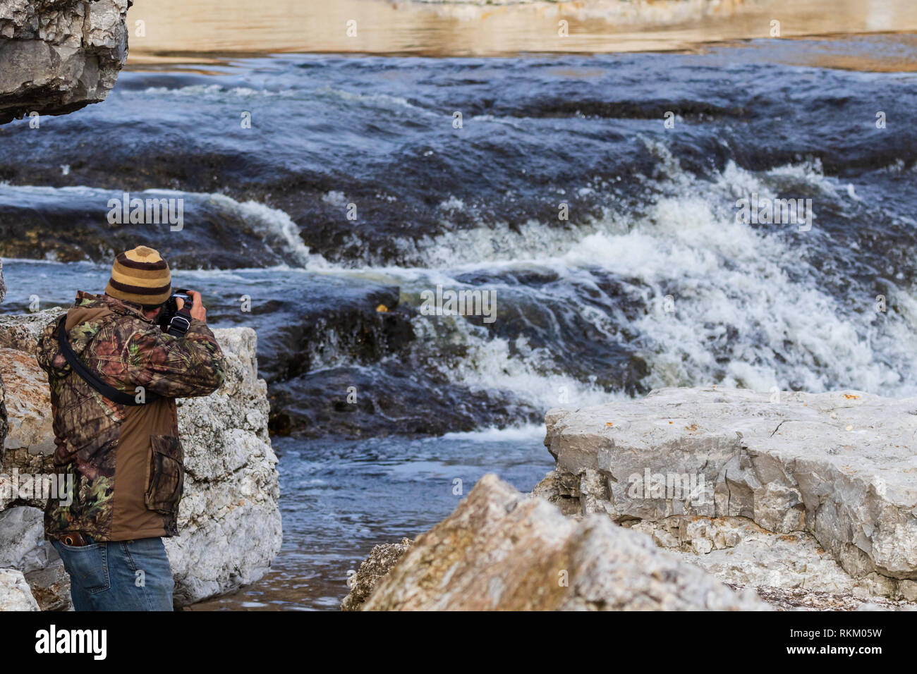 A 43 year old man taking a picture of the raging water near the Pensacola Dam located in Langley, Oklahoma 2019 Stock Photo