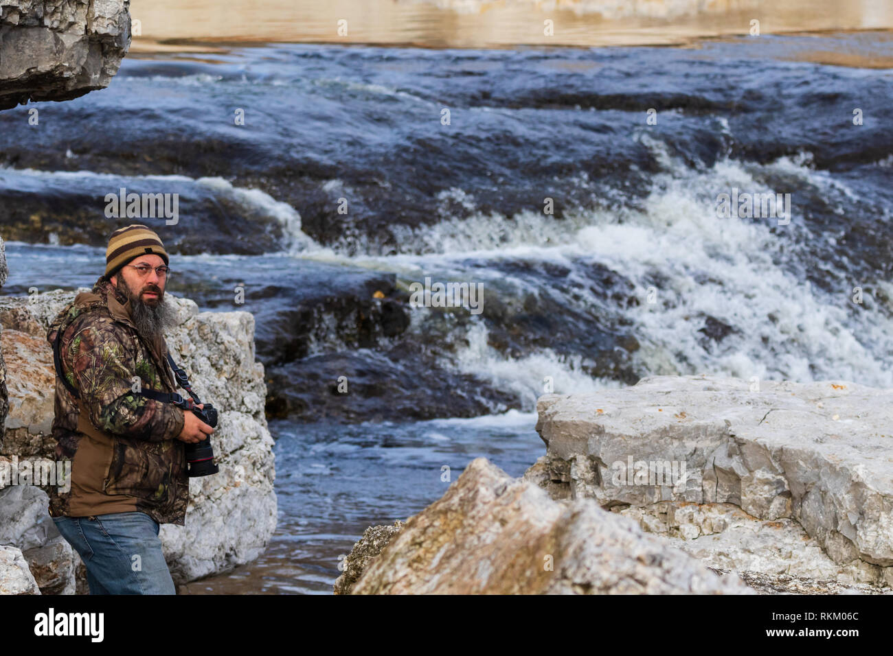 A 43 year old man taking a picture of the raging water near the Pensacola Dam located in Langley, Oklahoma 2019 Stock Photo