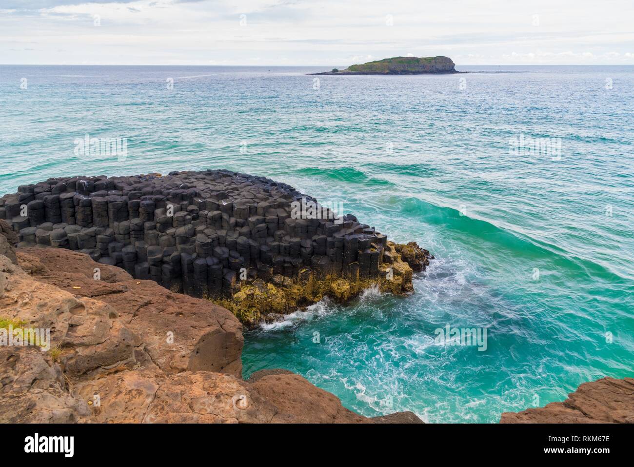 Crescent shaped hexagonal rock formations at Fingal Head, Australia