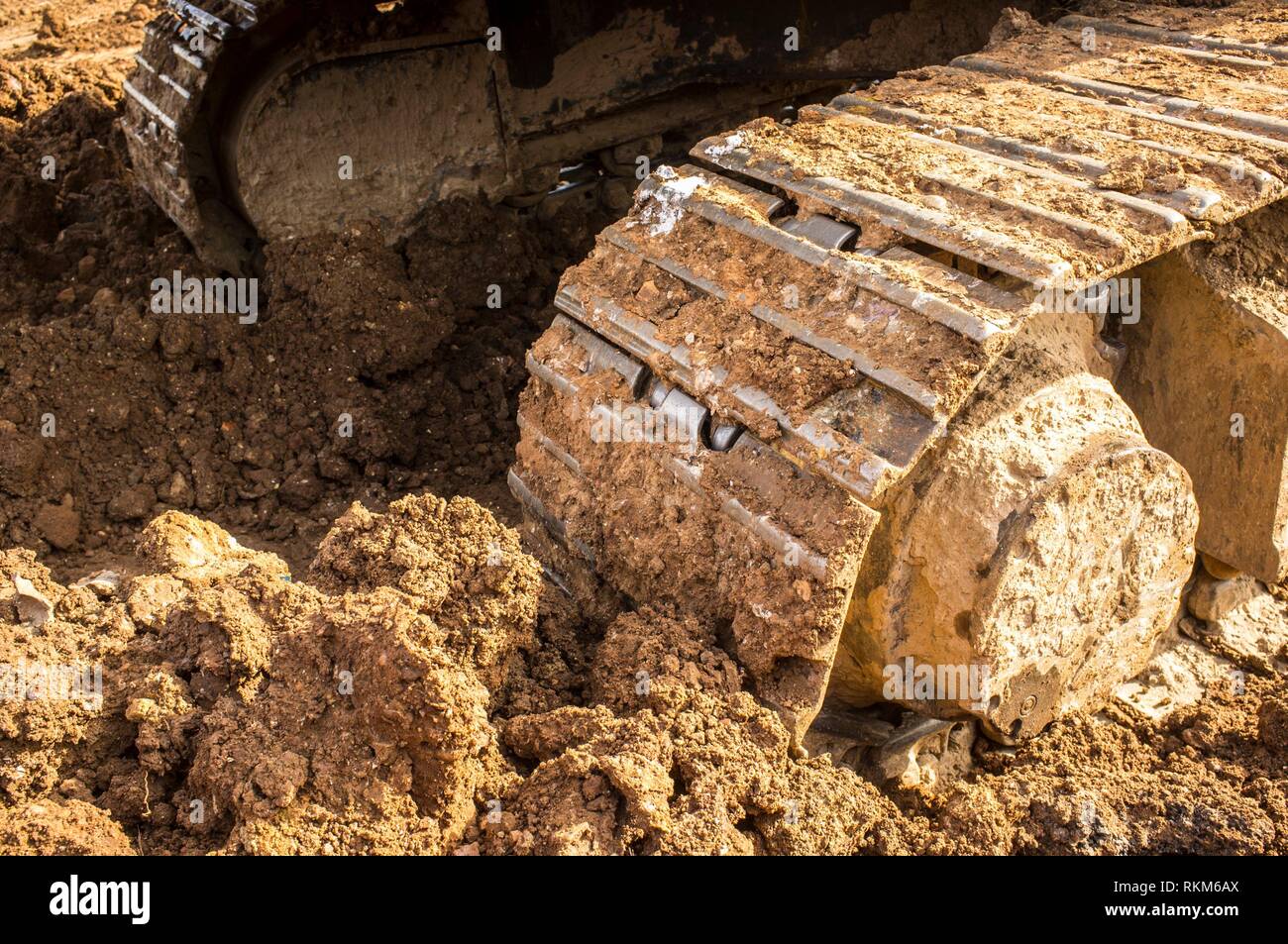 Excavator metal track shoe detail. Preparing the construction site soil. Stock Photo