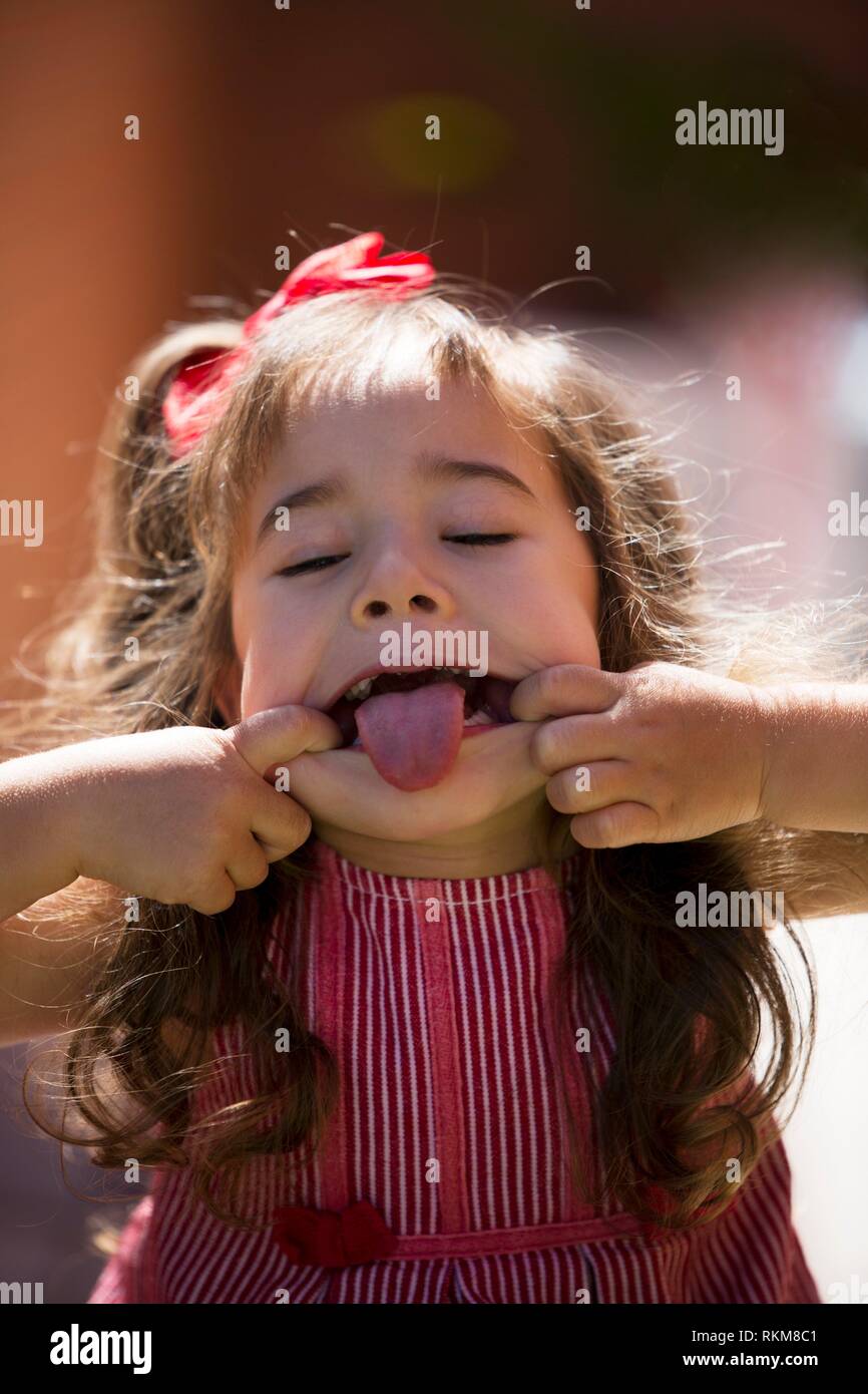 Cheeky girl pulling tongue out hires stock photography and images Alamy