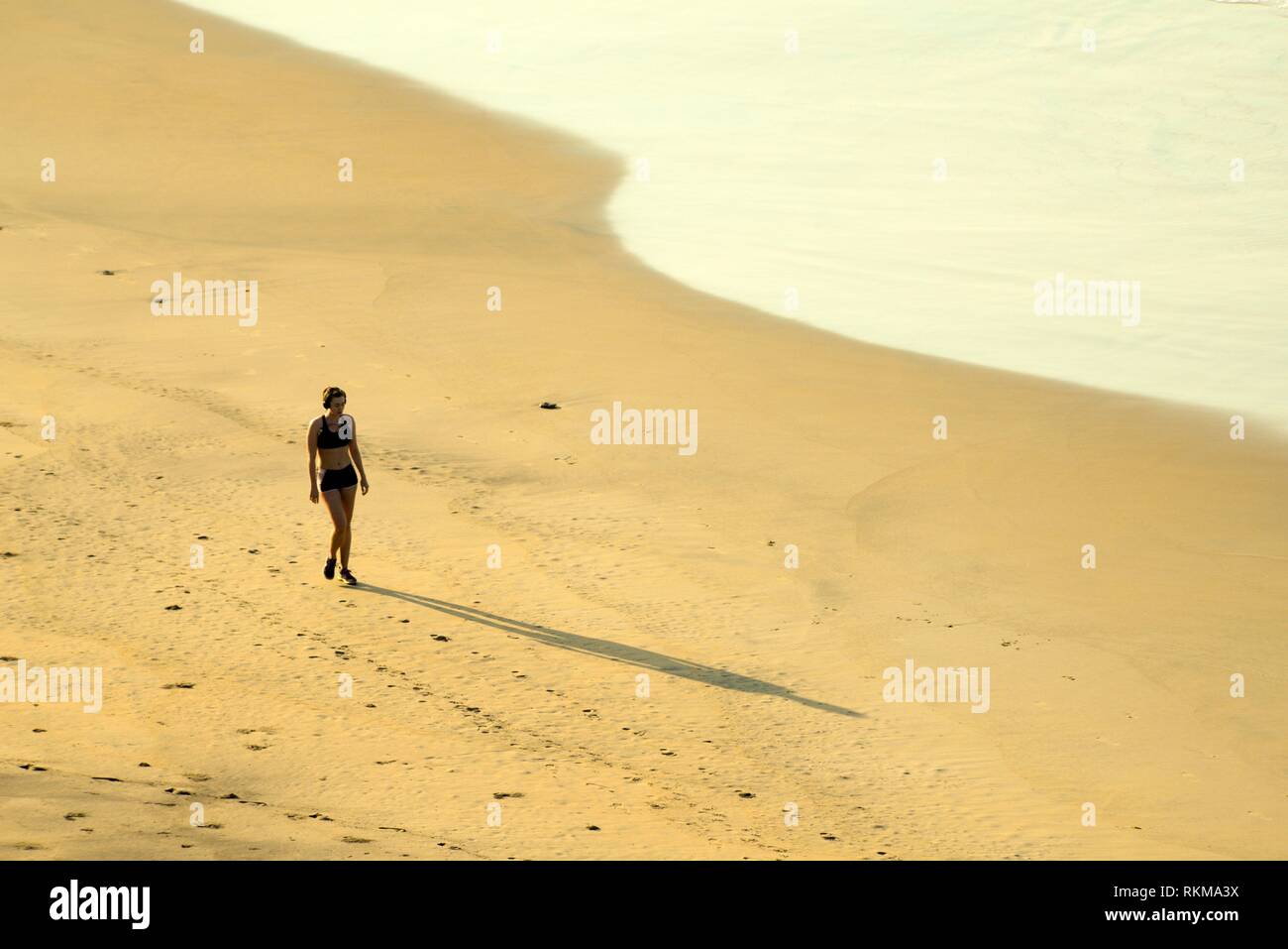 Woman, 26, walks on the beach at San Agustinillo, Oaxaca, Mexico. Stock Photo
