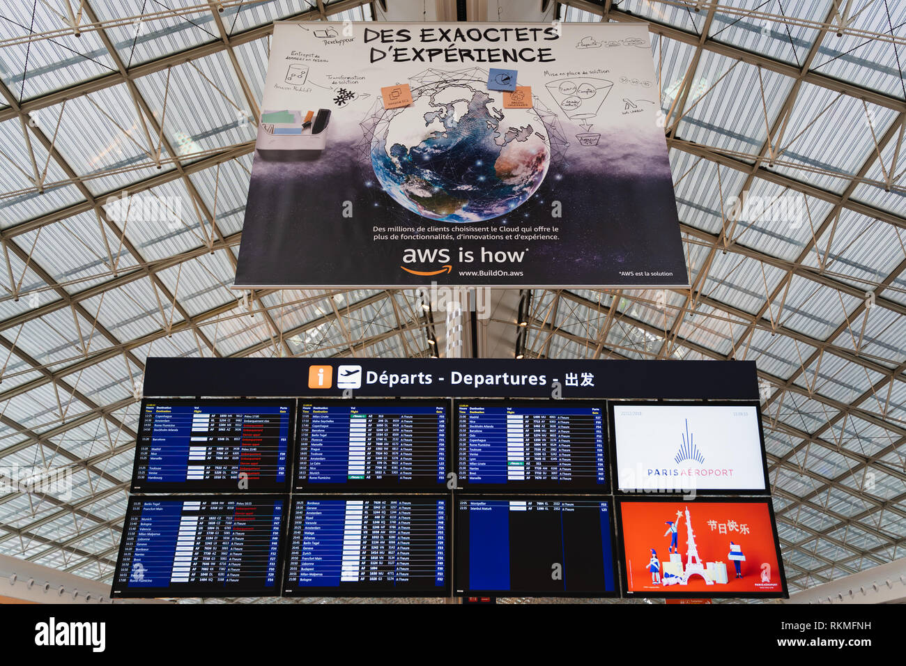 CDG Airport, Paris - 12/22/18: Departures information screen and aws amazon ad at Paris airport Charles de Gaule. buildon.aws Stock Photo
